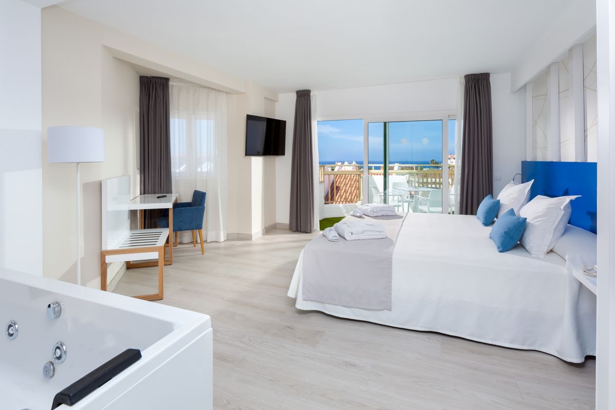Chambre d'hôtel moderne avec terrasse et vue sur la mer à Tenerife.