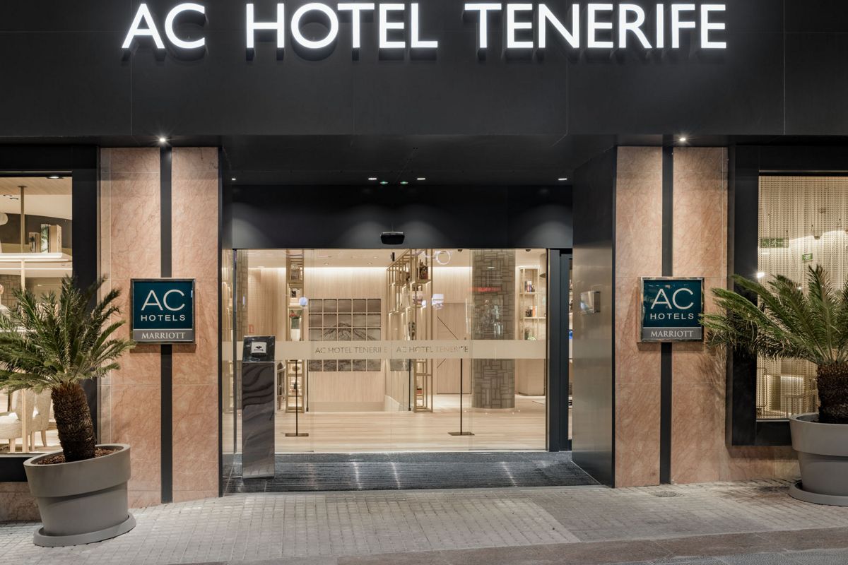Entrée de l’AC Hotel Tenerife, façade moderne avec enseignes et plantes.