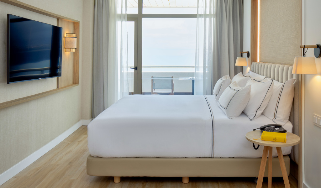 Chambre d'hôtel moderne avec lit double et vue sur mer à Tenerife.