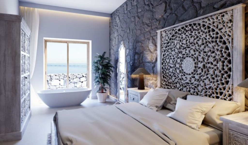 Chambre avec lit, fenêtre vue sur mer et baignoire à Tenerife.