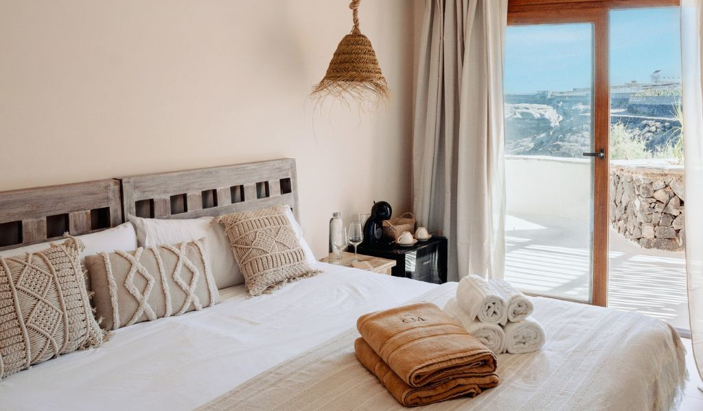 Chambre avec lit, serviettes et vue sur terrasse à Tenerife.