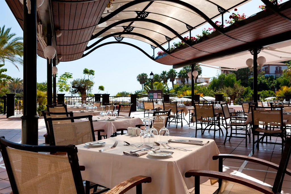 Tables de restaurant en terrasse à Tenerife, aménagées pour les clients avec couverts.