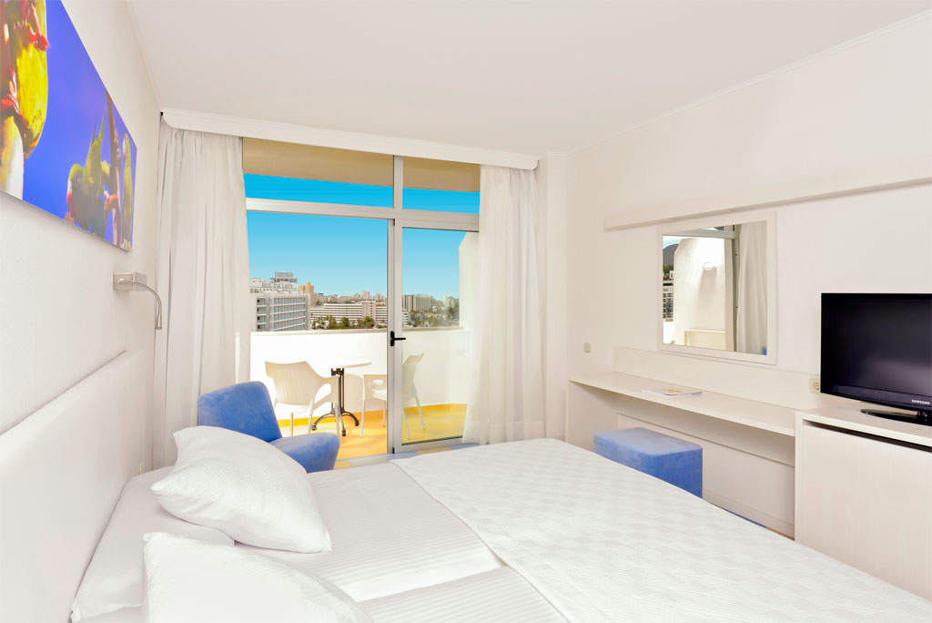 Chambre d'hôtel à Tenerife avec lit, balcon et vue sur la ville.