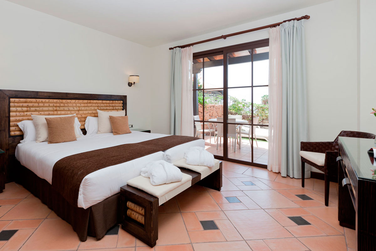 Chambre d'hôtel élégante avec lit double et terrasse à Tenerife.