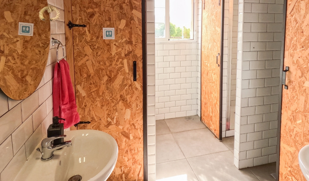 Salle de bain avec lavabo, miroir et porte en bois à Tenerife.