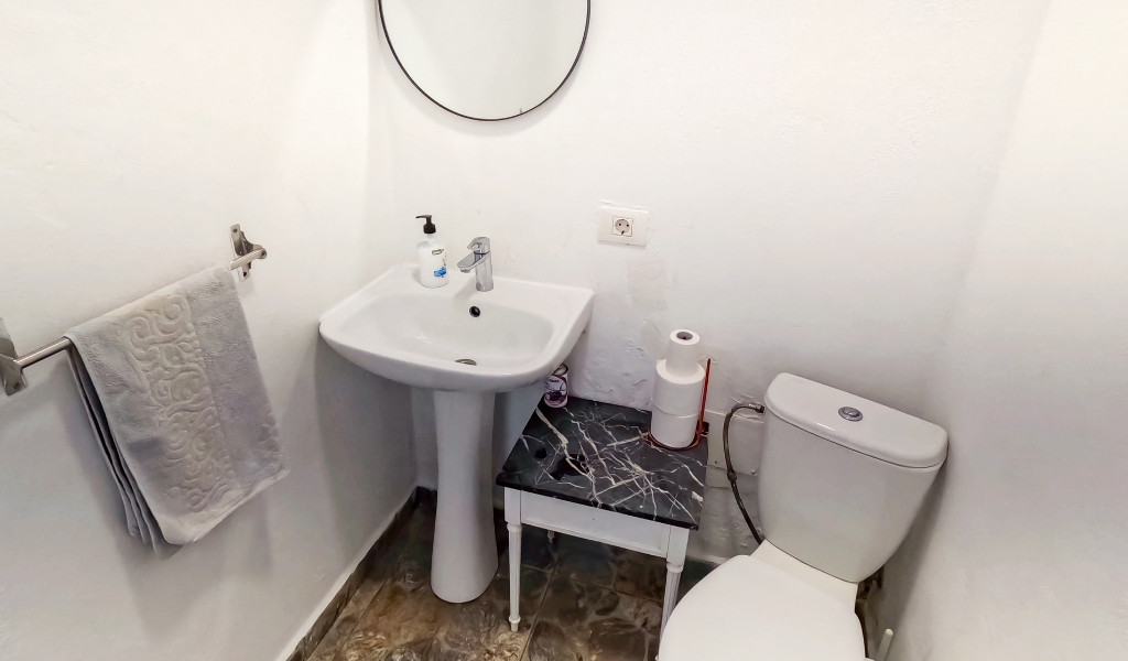 Lavabo et toilettes avec miroir et serviette, à Tenerife.