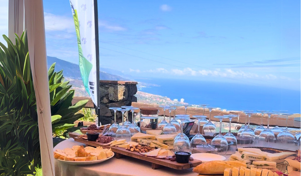 Plateau de fromages et verres vides avec vue sur la côte de Tenerife.