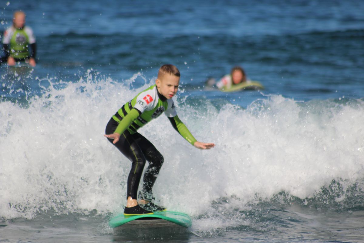 Garçon qui surfe sur une petite vague à Tenerife.