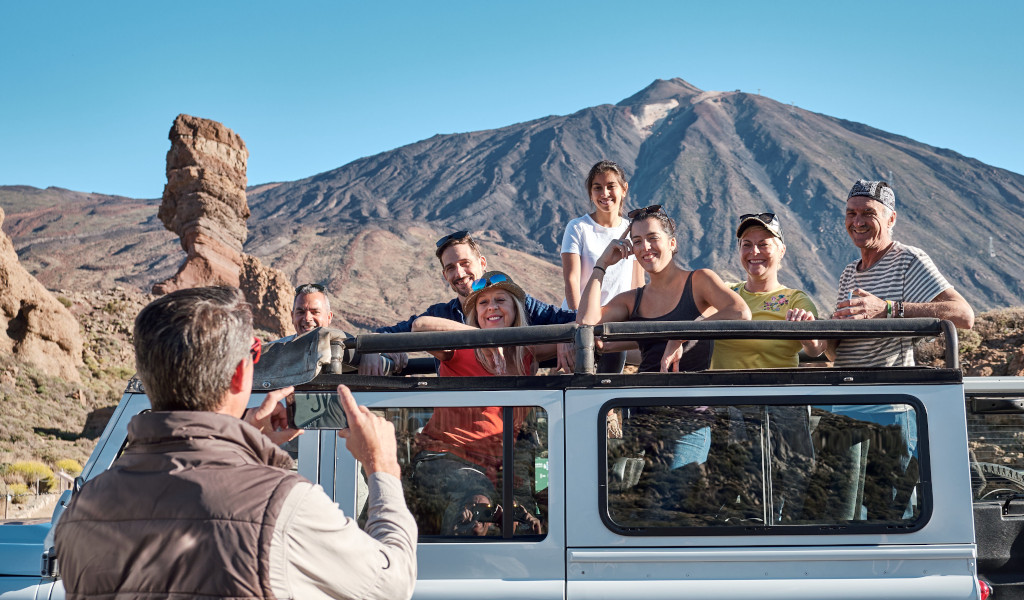 Groupe de personnes dans une jeep devant le mont Teide à Tenerife.