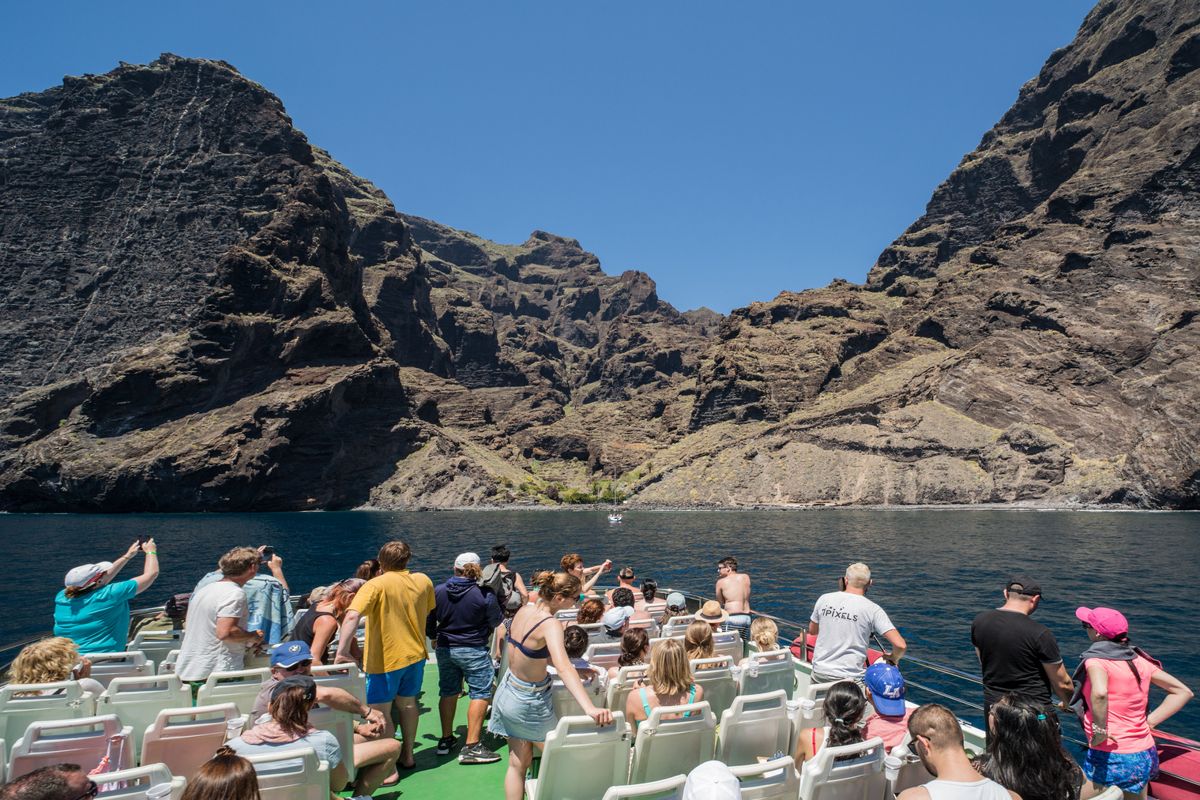 Des gens sur un bateau observant les falaises de Los Gigantes à Tenerife.