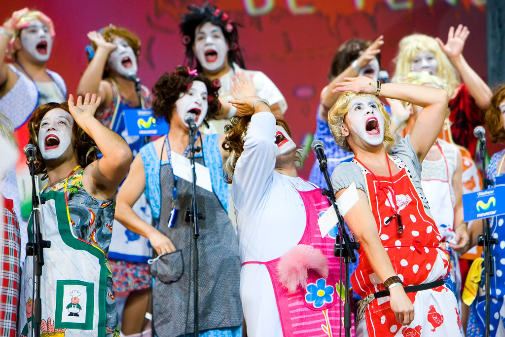 Des gens en costumes et visages peints chantant lors d’un événement à Tenerife.