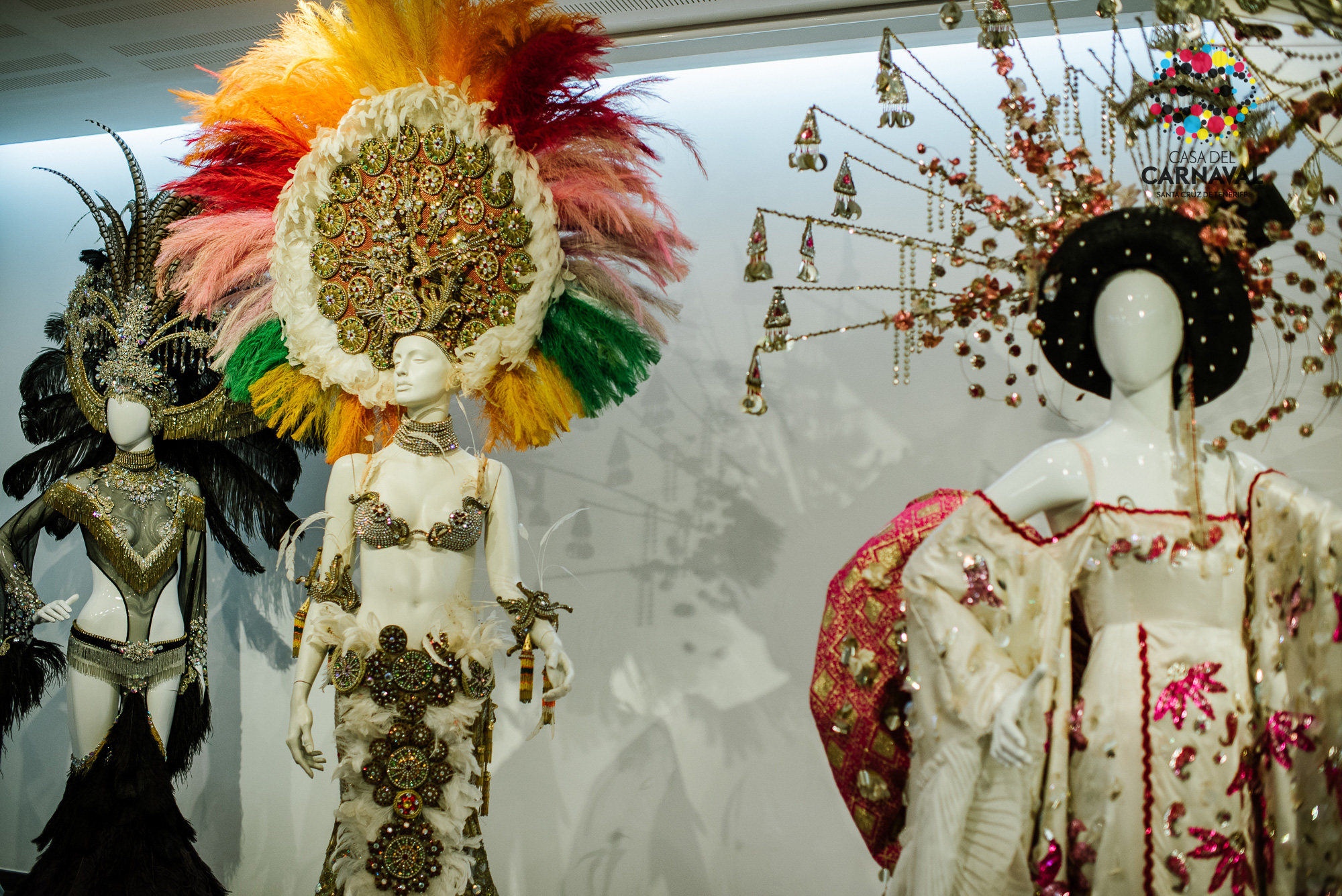 Mannequins en costumes du Carnaval de Santa Cruz de Tenerife, montrant des coiffes colorées.