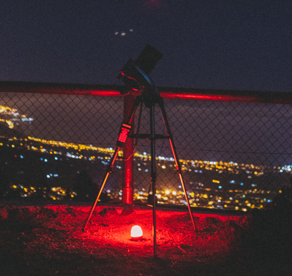 Télescope en belvédère, avec des lumières nocturnes urbaines à Tenerife.