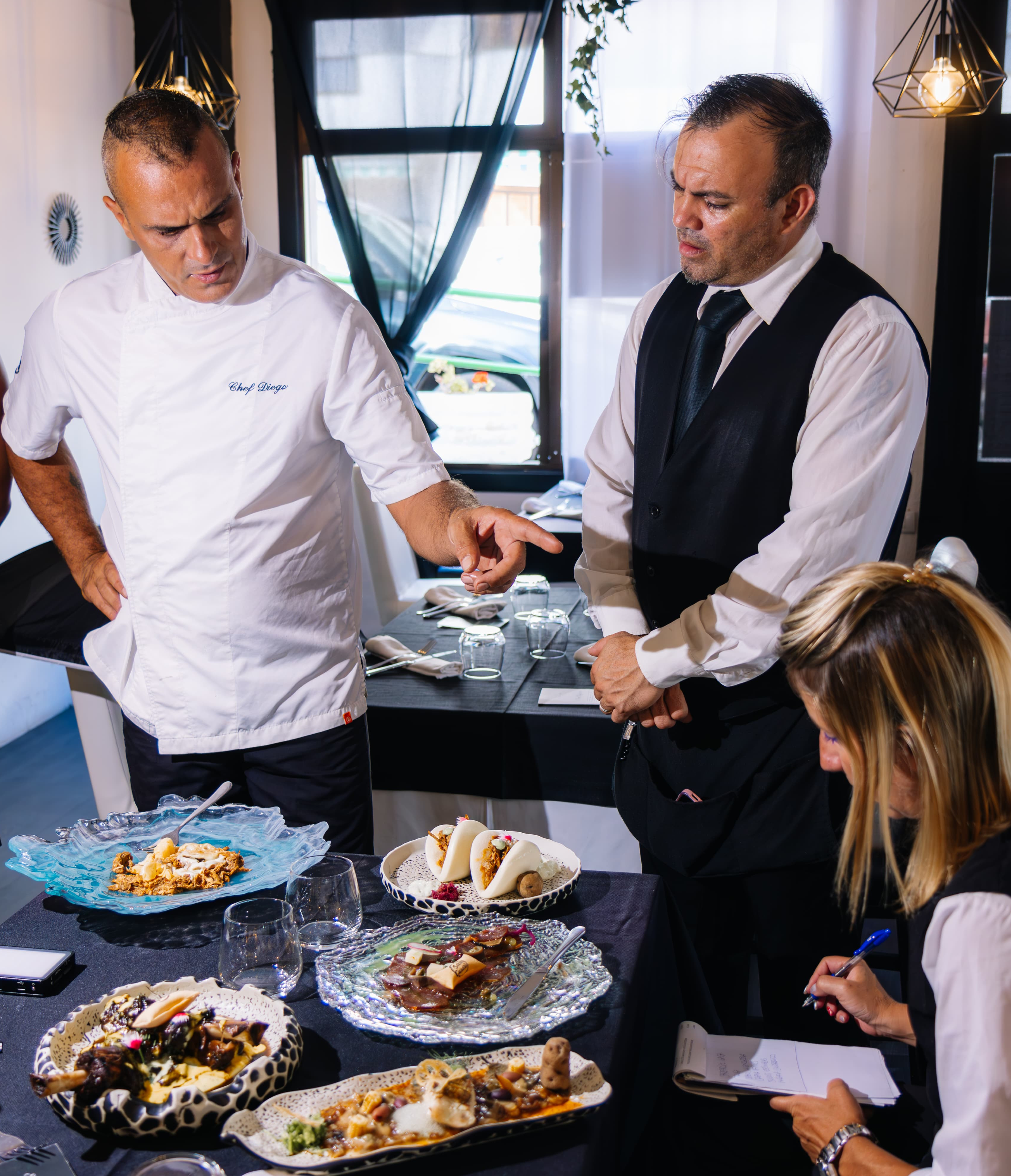 Chef et équipe critiquent des plats gastronomiques à Puerto de la Cruz, Tenerife.