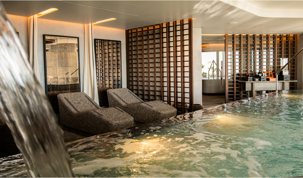 Piscine intérieure avec chaises longues et murs décoratifs à Tenerife.